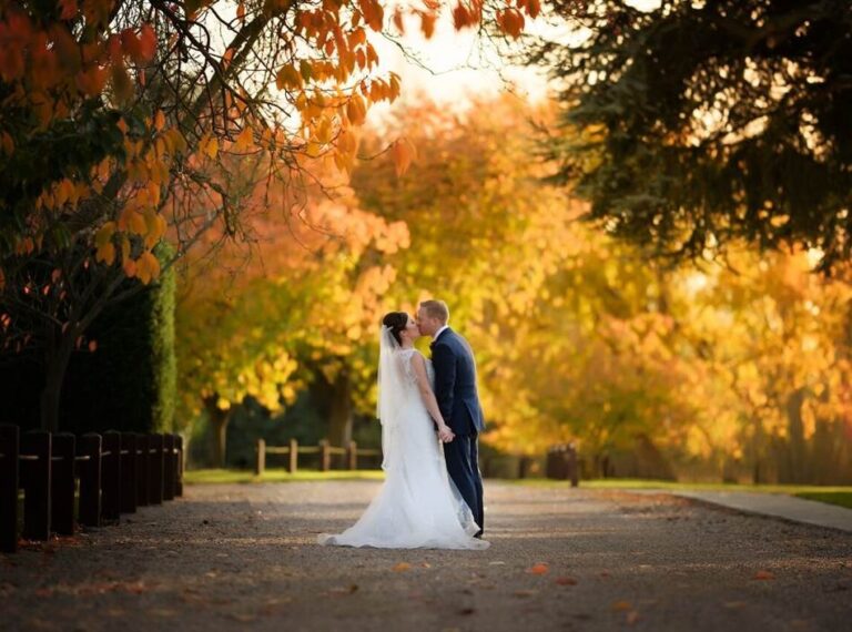 A couple among autumn trees on the drive, Down Hall Country House Hotel