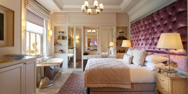 A bedroom with a tufted headboard, Down Hall Country House Hotel