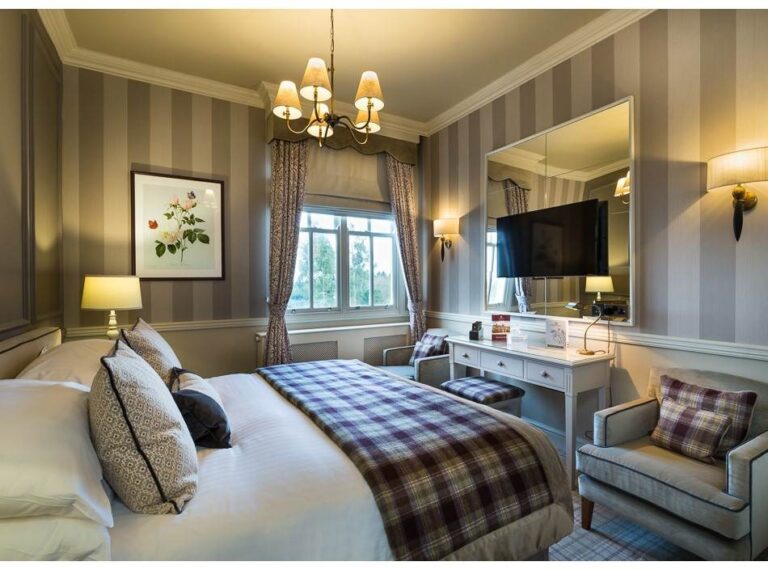 A double room with tartan throws, Down Hall Country House Hotel