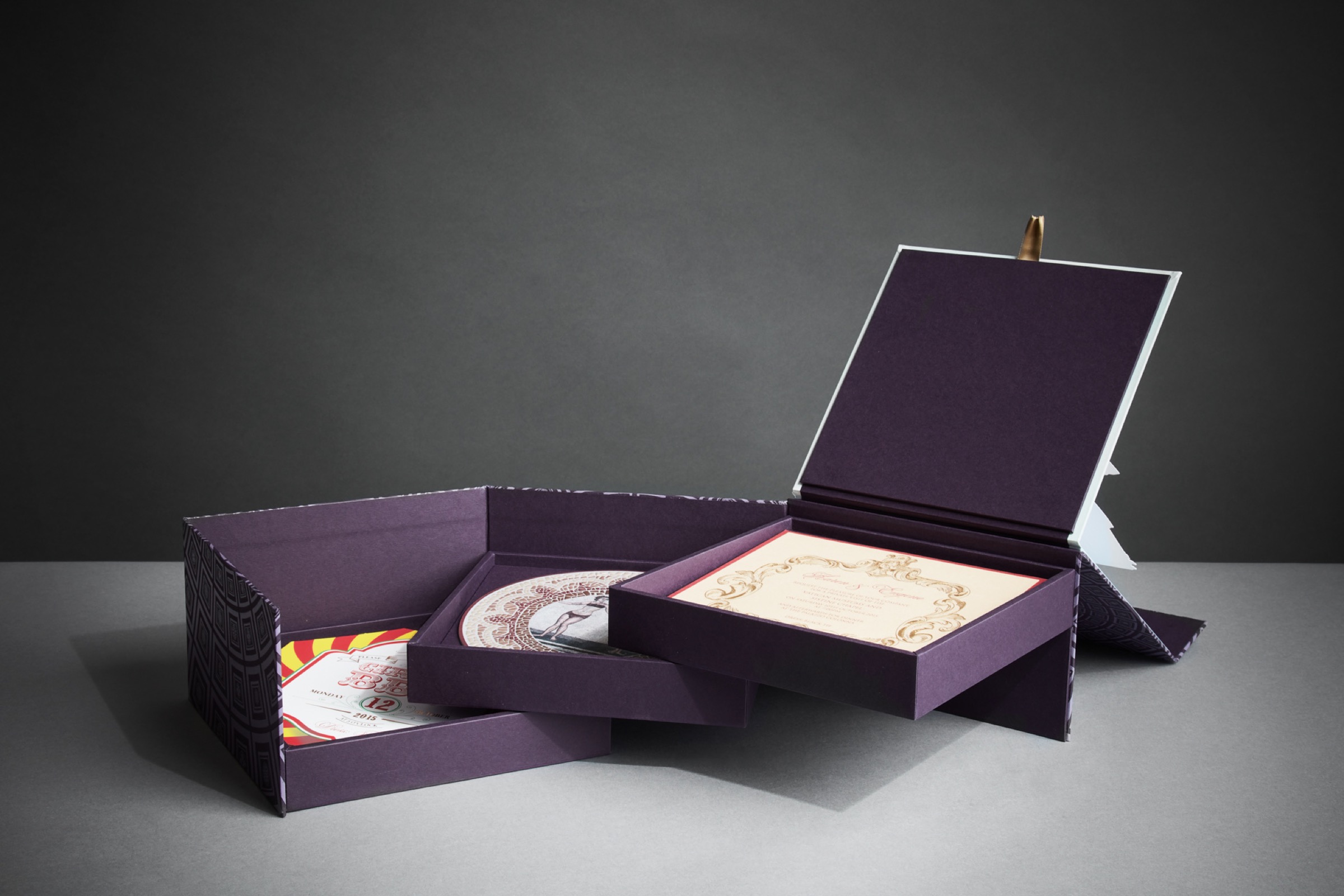 Layered invitation suite pulled open to show the ceremony invitation and event cards, Downey Luxury Stationery