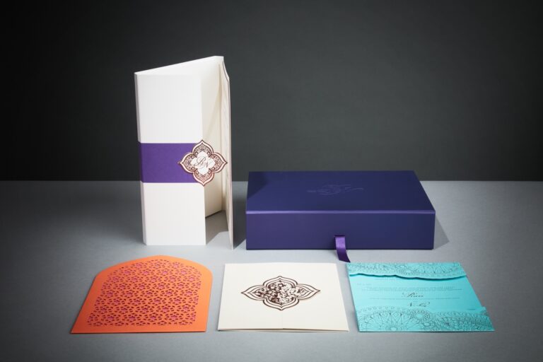 Indian wedding invitation suite laid out with turquoise, magenta and tangerine invitations and cream ceremony invitation, Downey Luxury Stationery