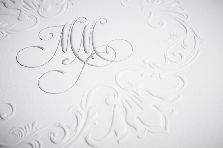 Blind embossed monogram with scrolling flourishes on white stock, Downey Luxury Stationery