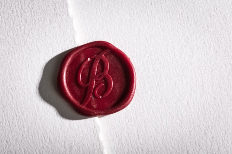 Hand-applied red wax seal with a monogram on deckle-edged paper, Downey Luxury Stationery