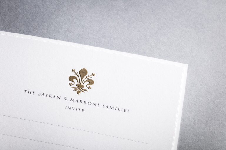 Deckle-edged invitation with a gold fleur-de-lis monogram, Downey Luxury Stationery