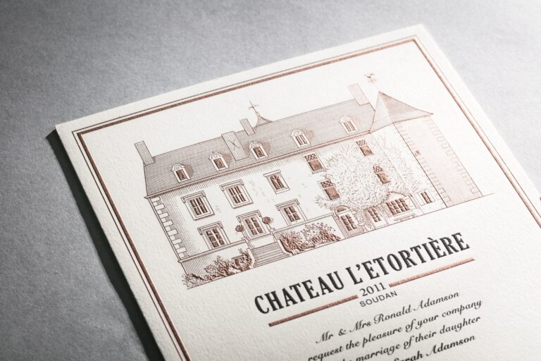 Invitation engraved with an illustration of the chateau in rose gold tones, styled like a wine label, Downey Luxury Stationery