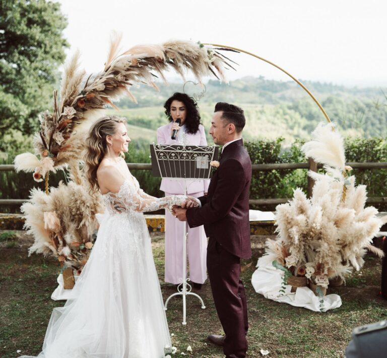 The celebrant officiating at the arch overlooking rolling hills, Dr Tiziana Di Molfetta