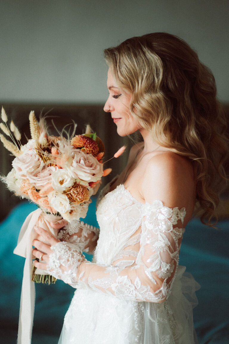 The bride looks down at her bouquet before the ceremony, Dr Tiziana Di Molfetta