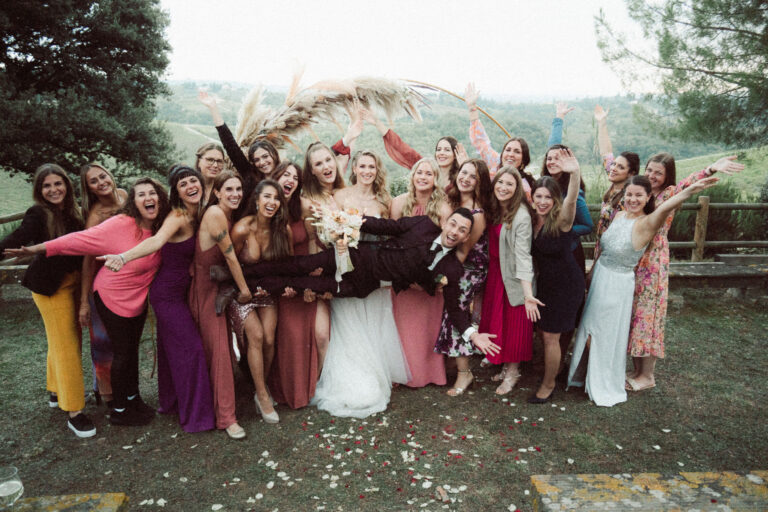 Wedding guests gather round the couple beneath the ceremony arch in the Florentine hills, Dr Tiziana Di Molfetta