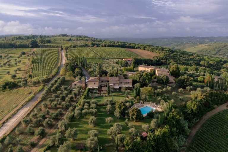 From the air: a country estate with olive groves, a pool and vineyards running to the horizon, Dream On Wedding Team