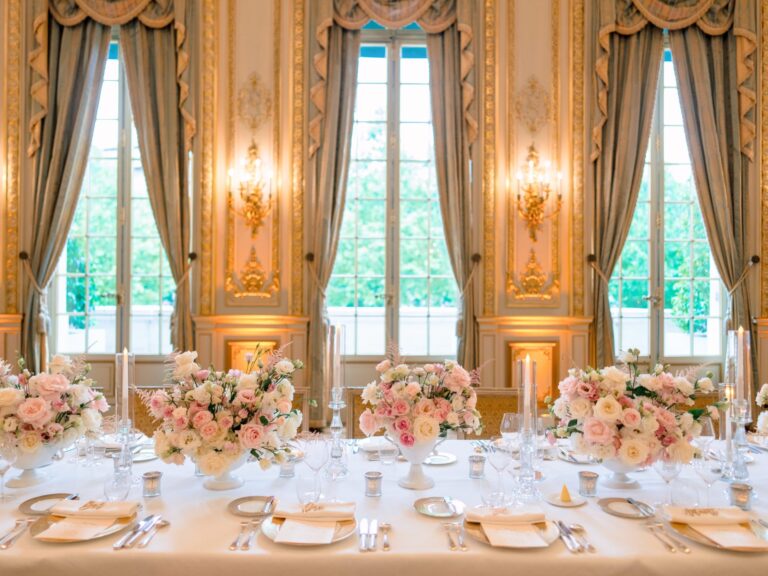Long reception table with pastel centrepieces before tall draped windows, Dream Paris Wedding