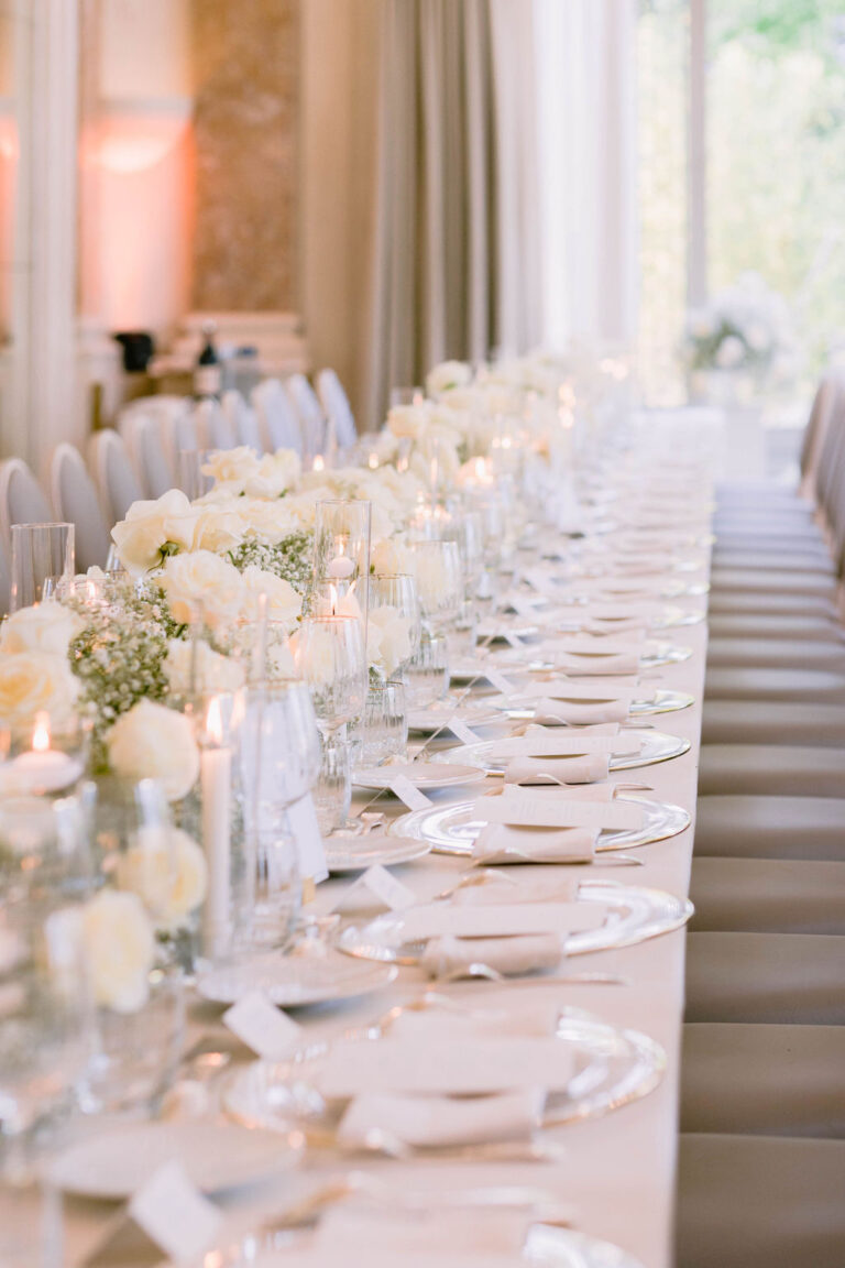 Long candlelit table with low white flowers and glassware, Dream Paris Wedding