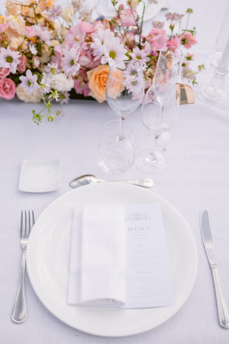 White place setting with menu and a spray of pink flowers, Dream Paris Wedding