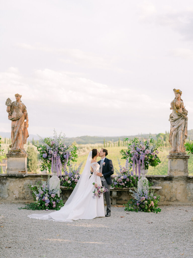 Couple between stone statues and lilac flowers on a villa terrace, Italy, Dream Weddings By Francesca Resciniti