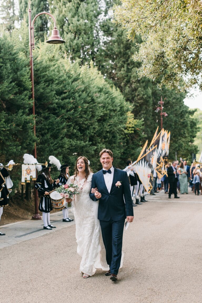 Newlyweds leading a procession of Tuscan flag weavers, Castelfalfi, Dream Weddings By Francesca Resciniti