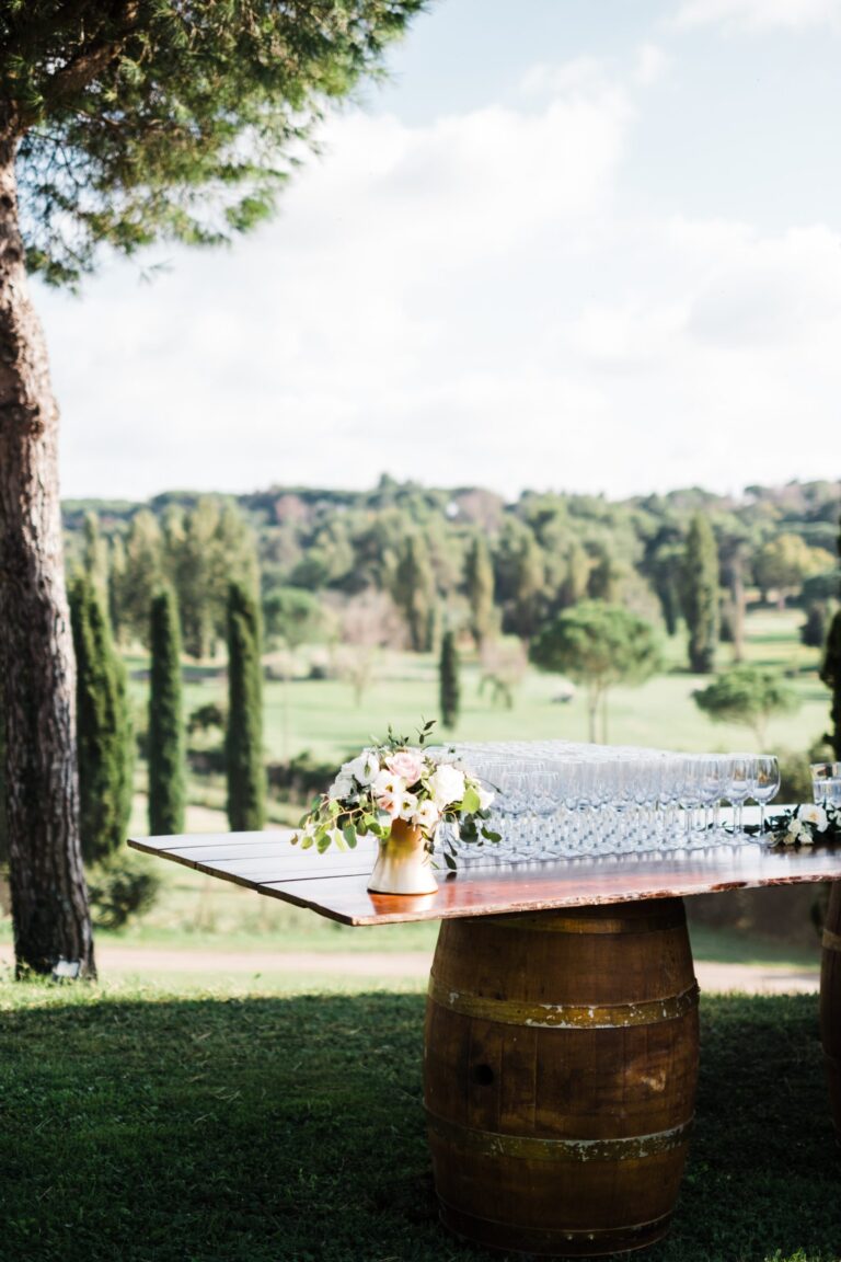 Welcome table on a wine barrel with flowers, Casale del Gallo, Roman countryside, Dream Weddings By Francesca Resciniti