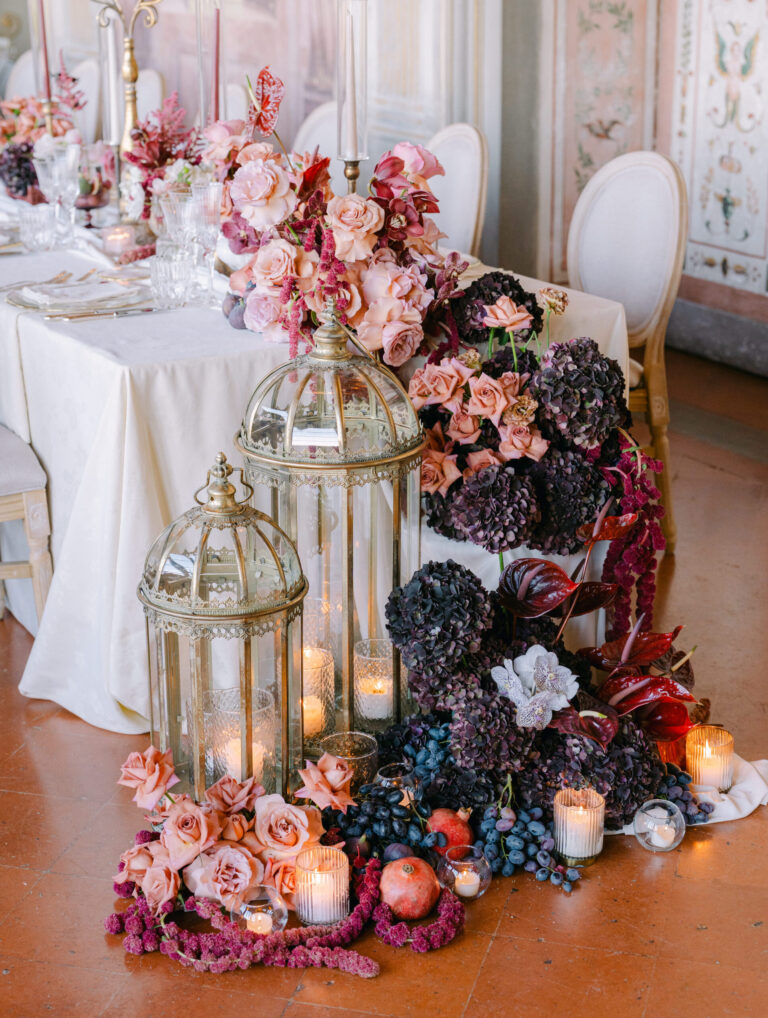 Table with lanterns and a cascade of roses, hydrangeas and fruit, Italy, Dream Weddings By Francesca Resciniti