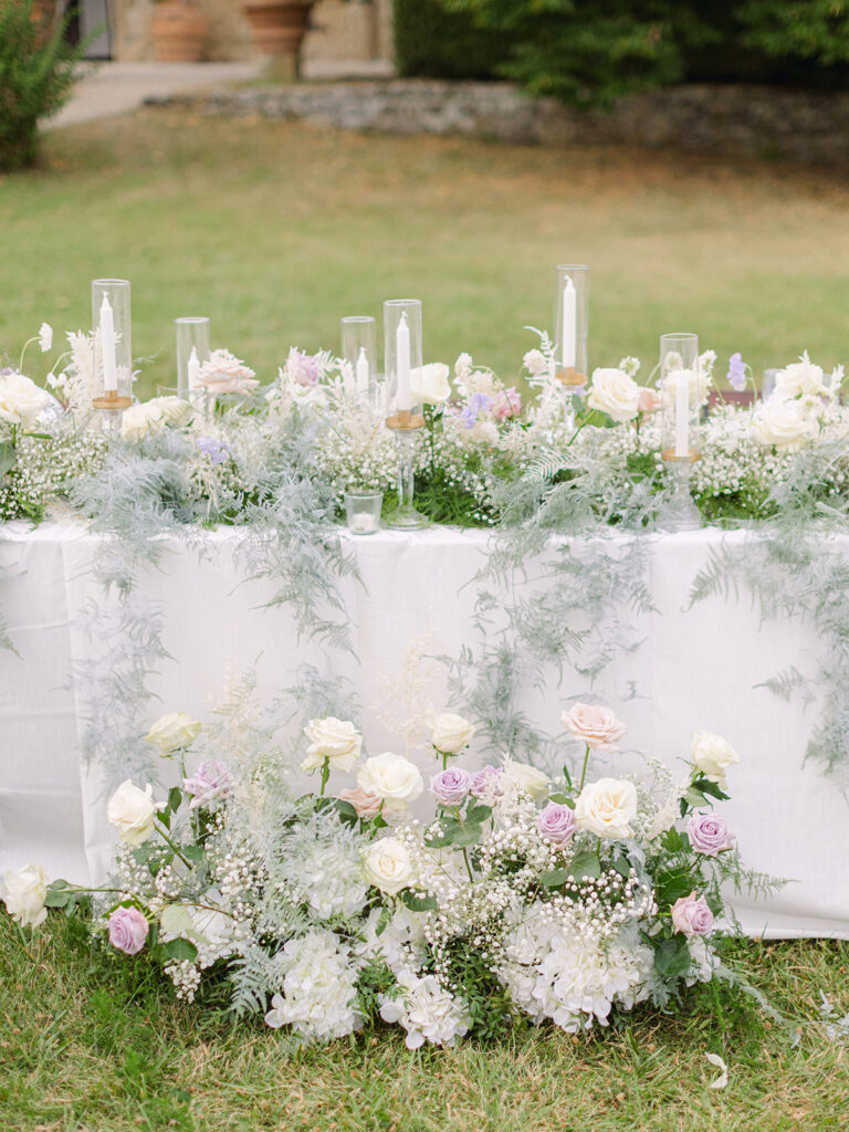Low white and lilac floral runner with candles along a garden table, Italy, Dream Weddings By Francesca Resciniti