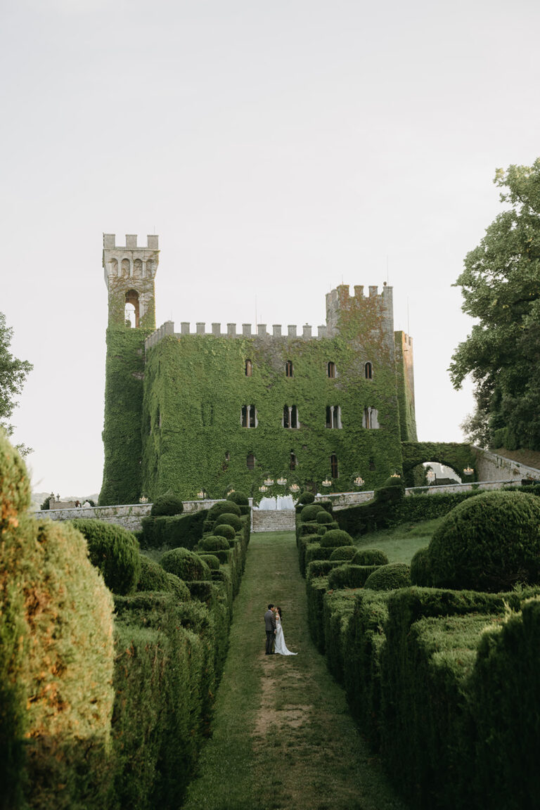 Couple in a clipped hedge garden below an ivy-covered castle, Italy, Dream Weddings By Francesca Resciniti