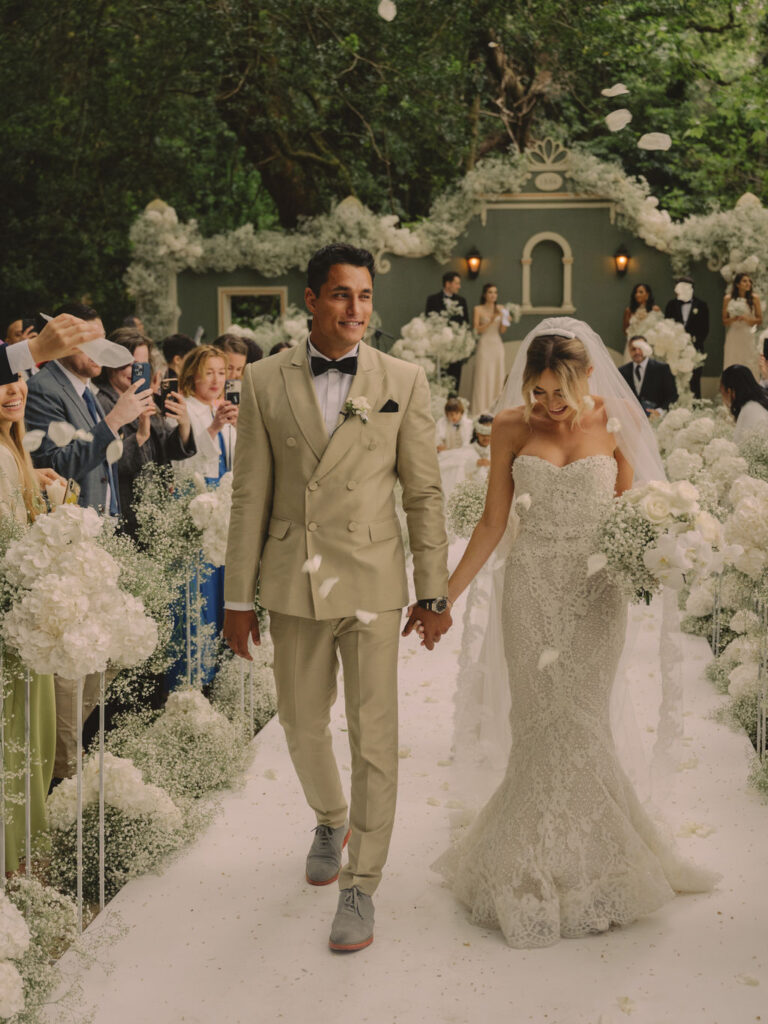 Couple walking the white-flower aisle after the ceremony, Dream Weddings Europe