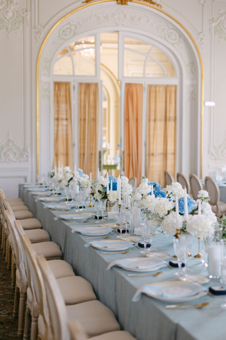Long table dressed in pale blue with white flowers and gold chairs, Dream Weddings Europe