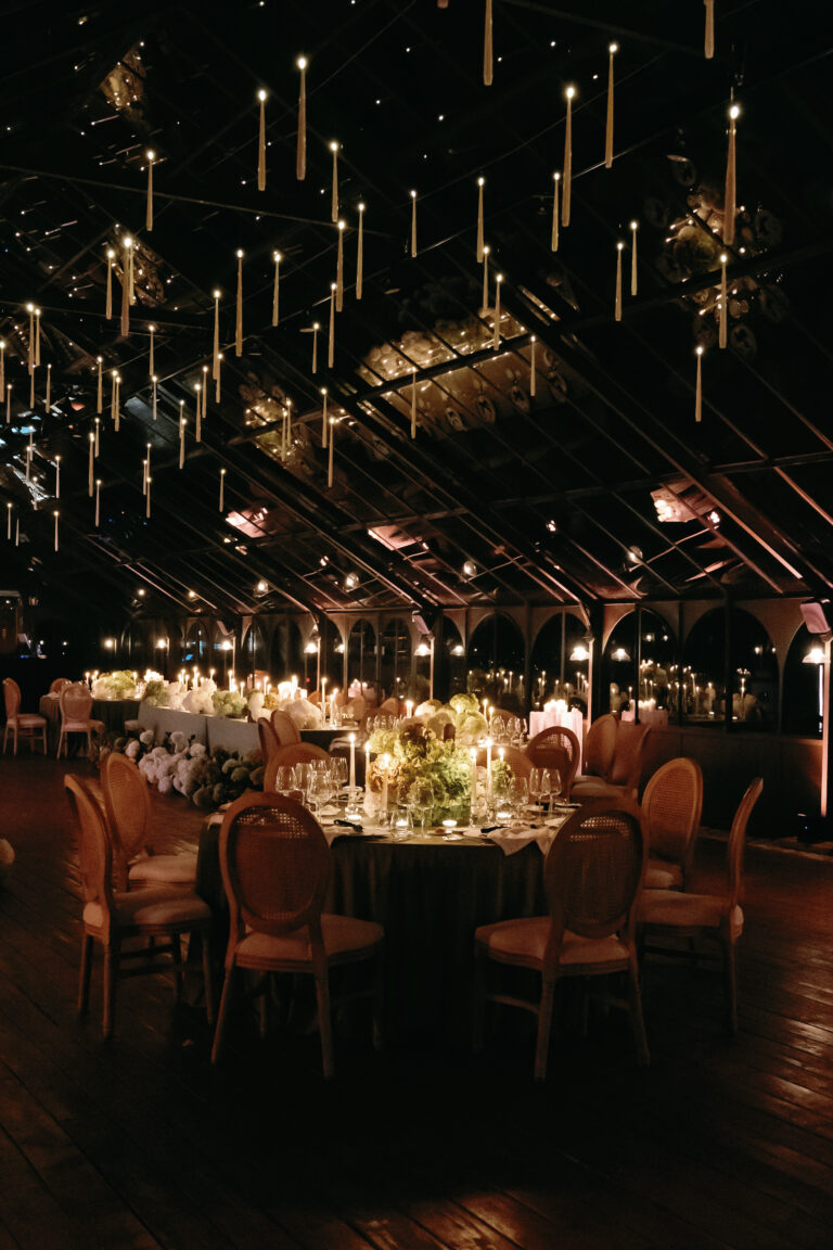 Dining tent at night with hanging candles and round tables, Dream Weddings Europe