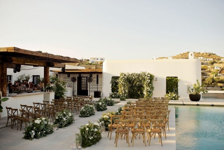Ceremony chairs and floral borders set beside a pool, Dream Weddings Mykonos