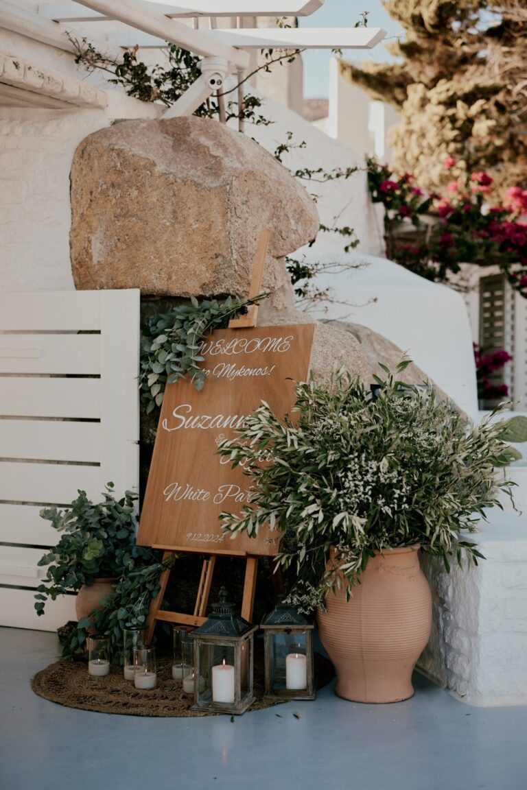 Hand-lettered welcome sign among olive plants and white walls, Dream Weddings Mykonos