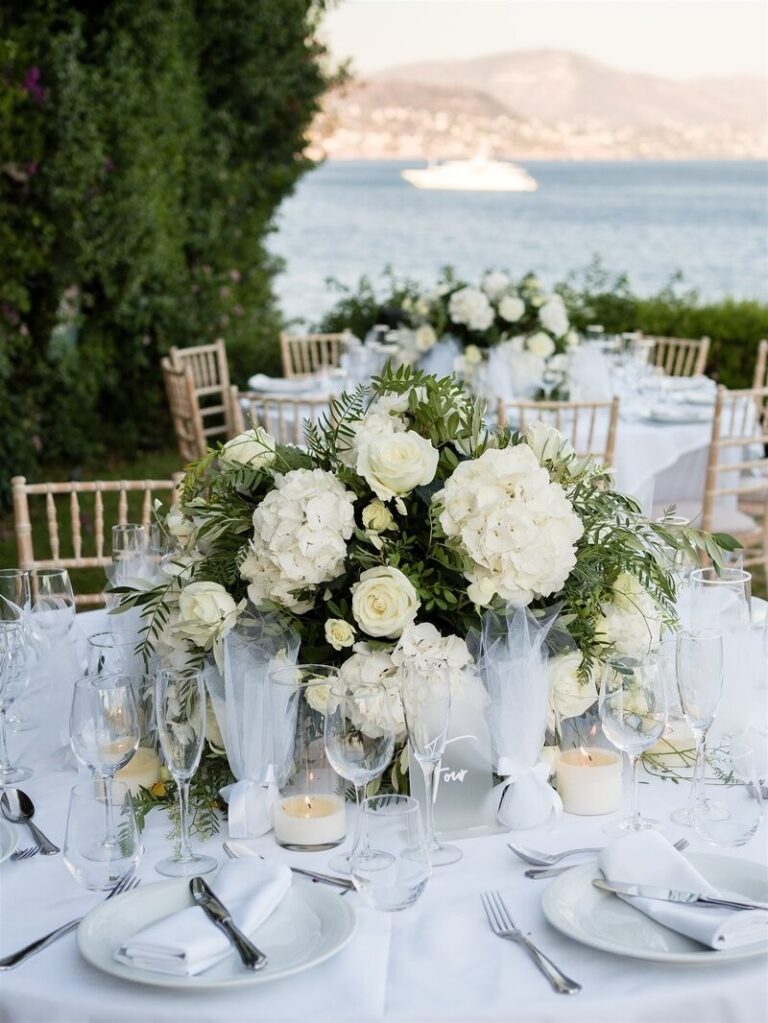 Table dressed in white with a tall arrangement of white flowers, Dream Weddings Mykonos