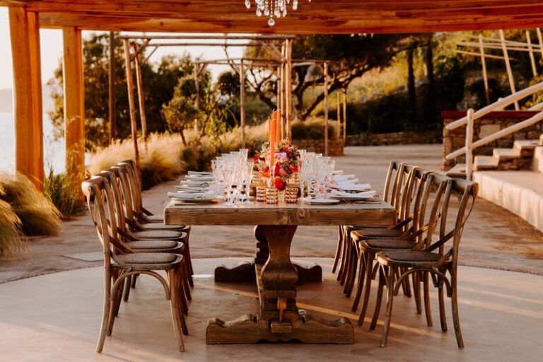 Long timber table set under a pergola at golden hour, Dream Weddings Mykonos