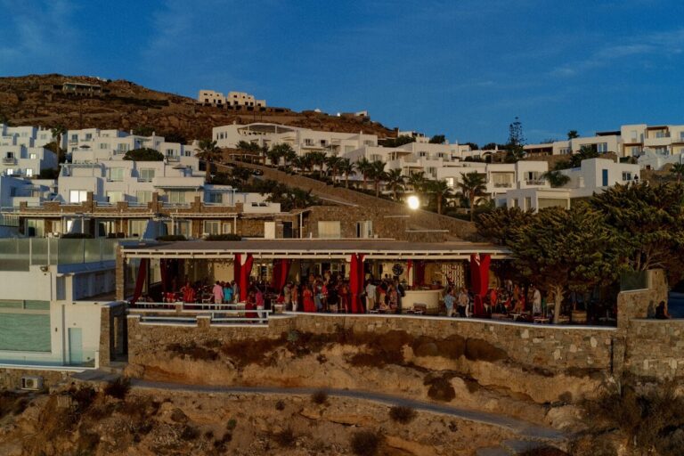 A hillside venue dressed in red drapes for an evening celebration, Dream Weddings Mykonos