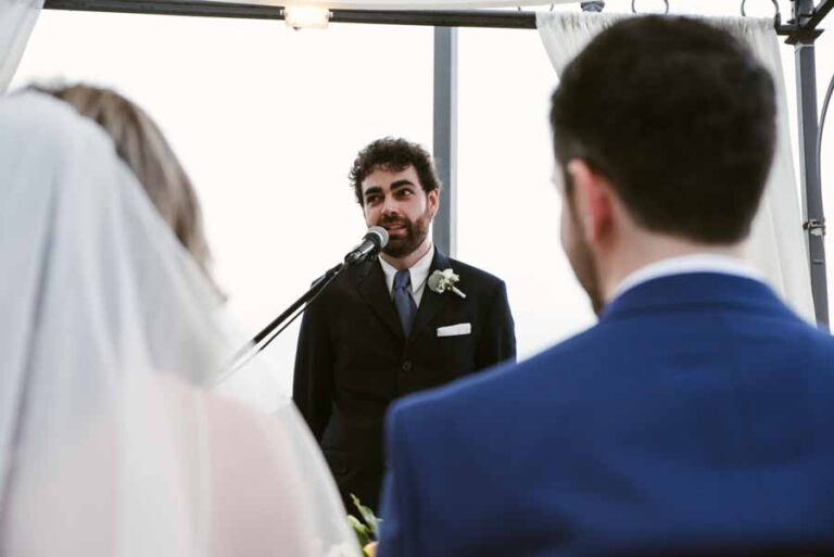 Groom speaking his vows into a microphone at an outdoor ceremony, DS Studiofotografico