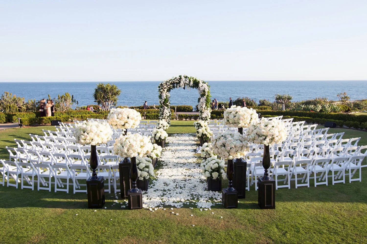 Outdoor ceremony seating and floral arch above the ocean, Montage Laguna Beach, Duke Photography