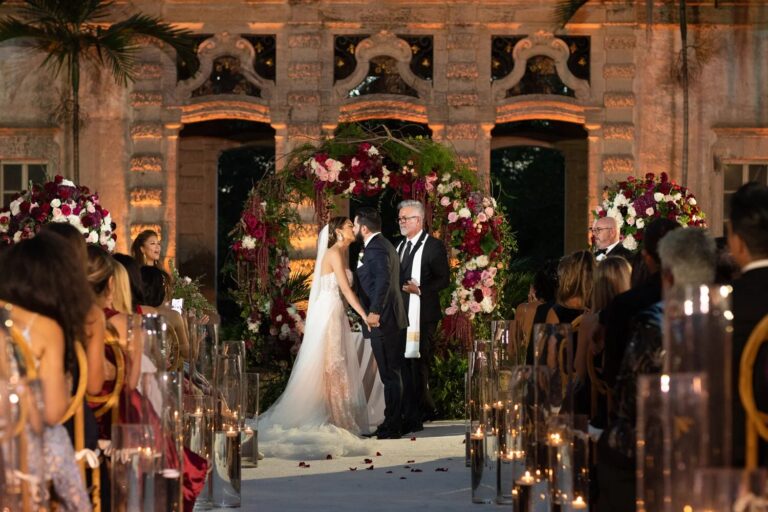 Ceremony before a floral arch in the courtyard, Vizcaya Museum and Gardens, Miami, Duke Photography