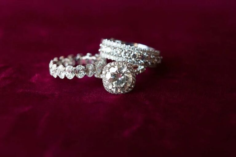Diamond engagement ring and band on burgundy velvet, Duke Photography