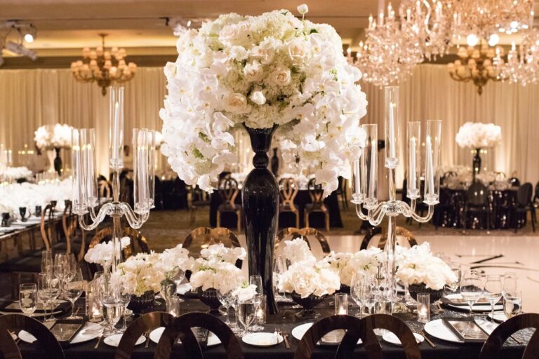 Reception table with a tall white floral centrepiece and candelabra, Montage Laguna Beach, Duke Photography