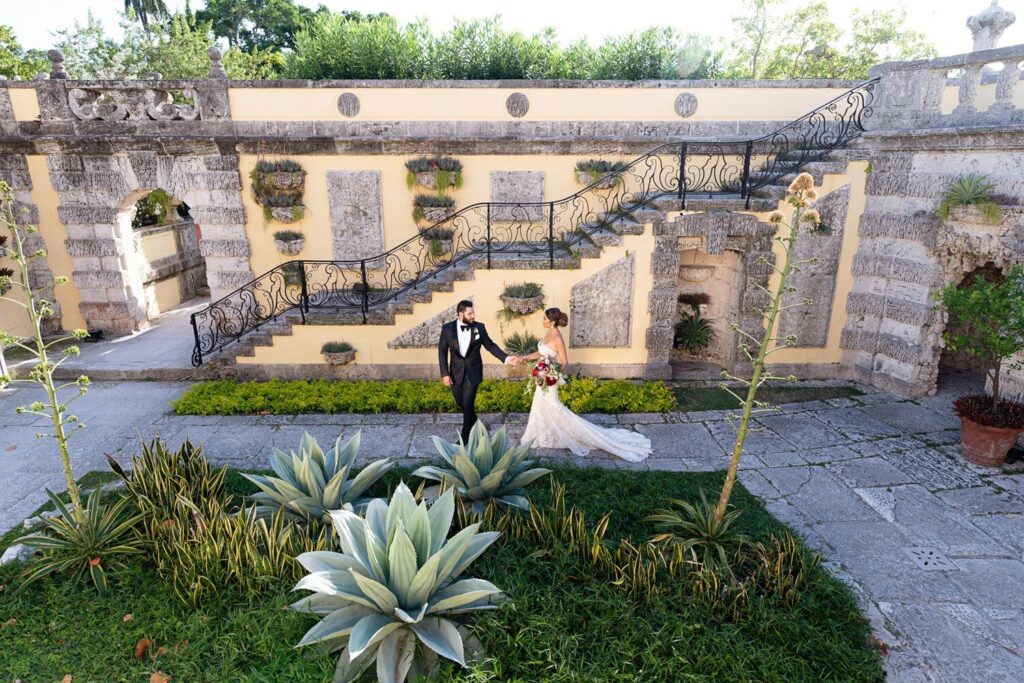 A couple crossing the formal garden courtyard at Vizcaya