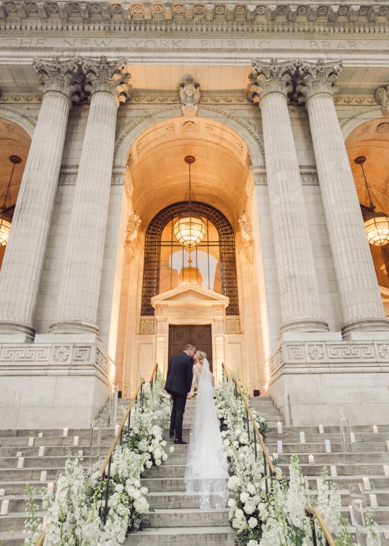 Couple on the steps of a New York landmark library, lined with white flowers, Duke Photography