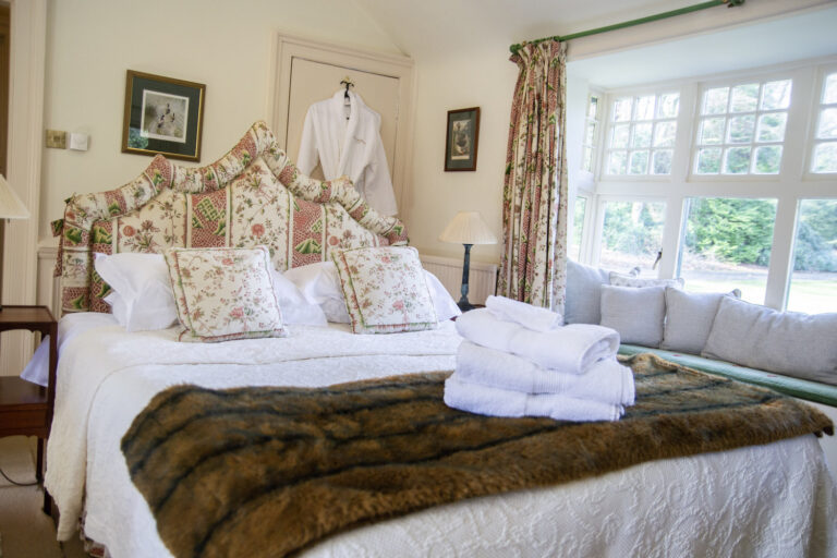 A double bedroom with a window seat and views over the gardens, Dundas Castle