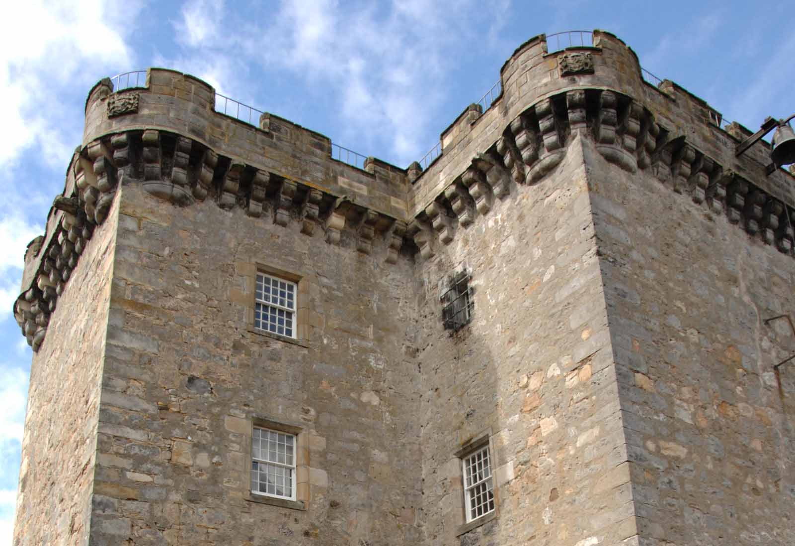 The 15th-century Auld Keep, a square stone tower with a corbelled parapet, Dundas Castle