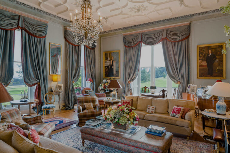 The Drawing Room with tall windows over the lawns, a chandelier and deep sofas, Dundas Castle
