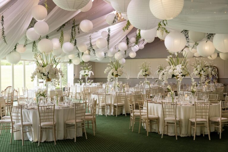 The Pavilion set for a wedding breakfast, with paper lanterns, draped ceiling and tall white arrangements, Dundas Castle