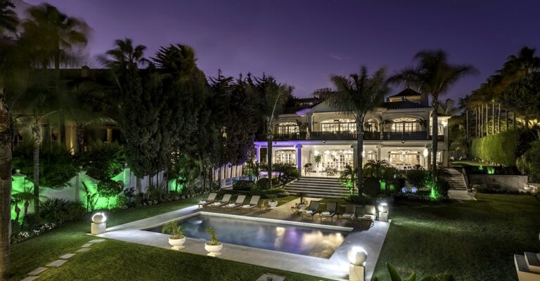 The villa and the lit pool at dusk, from the air, El Martinete Villa