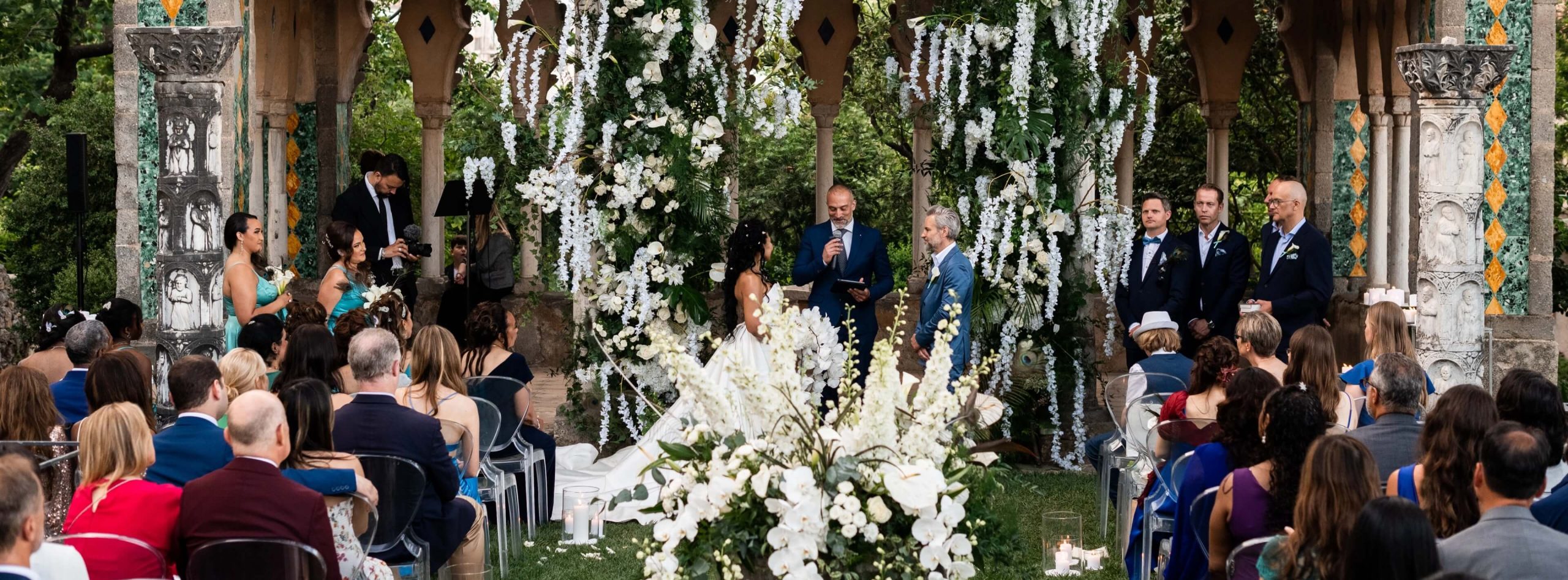 A ceremony beneath a canopy of white flowers in the gardens of Villa Cimbrone, Ravello, Elisa Prati Wedding Italy
