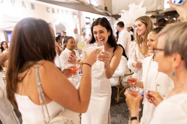 Guests in white raising a toast at a street party, Capri, Elisa Prati Wedding Italy