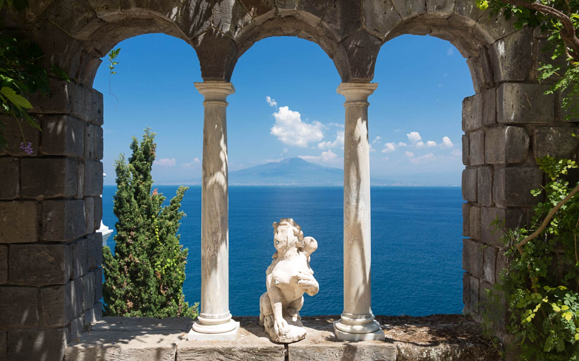 A stone loggia with a classical statue framing the bay, Vesuvius on the horizon, Amalfi Coast, Elisa Prati Wedding Italy