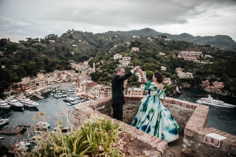 The couple dancing on a terrace above Portofino harbour, yachts and painted houses below, Elisa Prati Wedding Italy