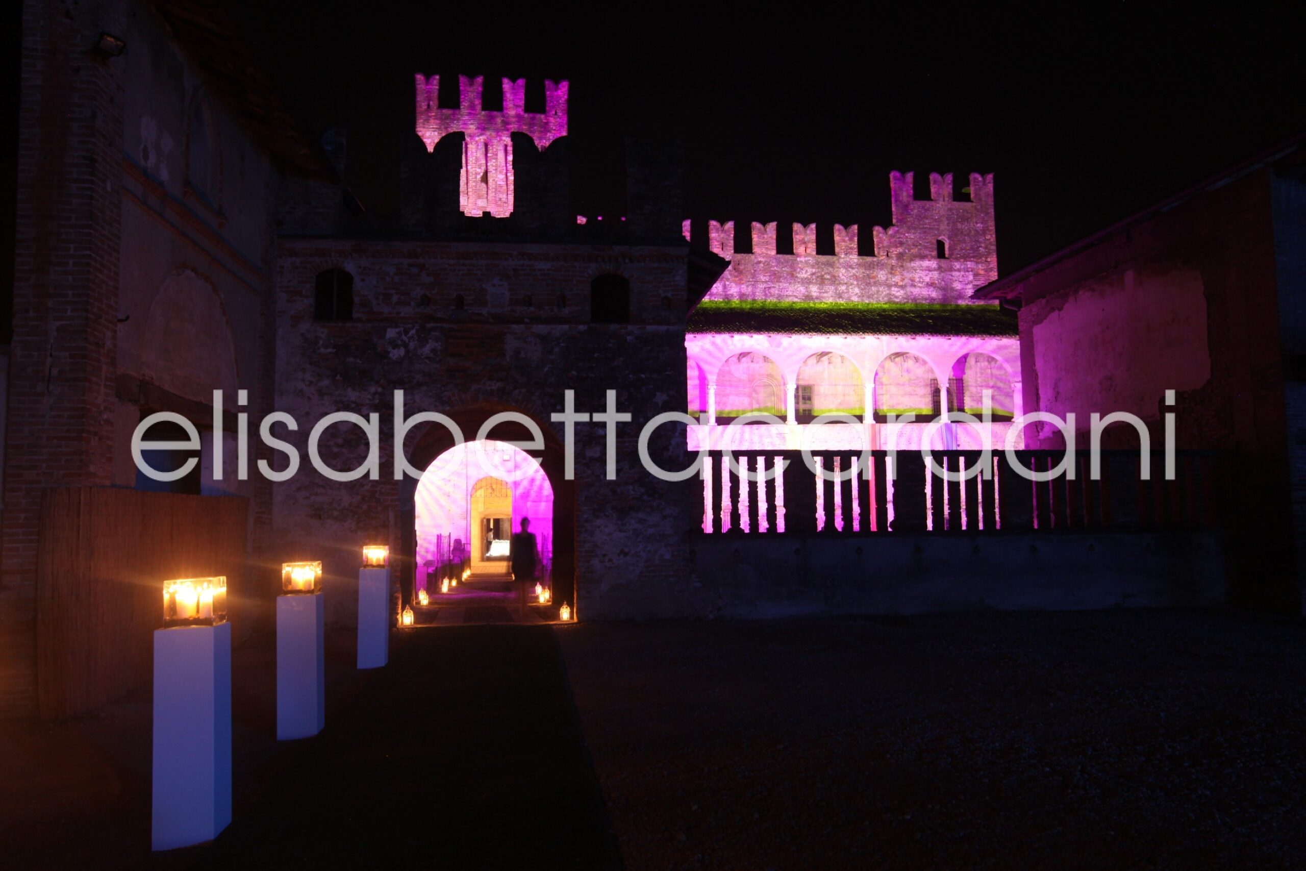 Castello di Malpaga lit for the evening, the keep in pink light, Elisabetta Cardani