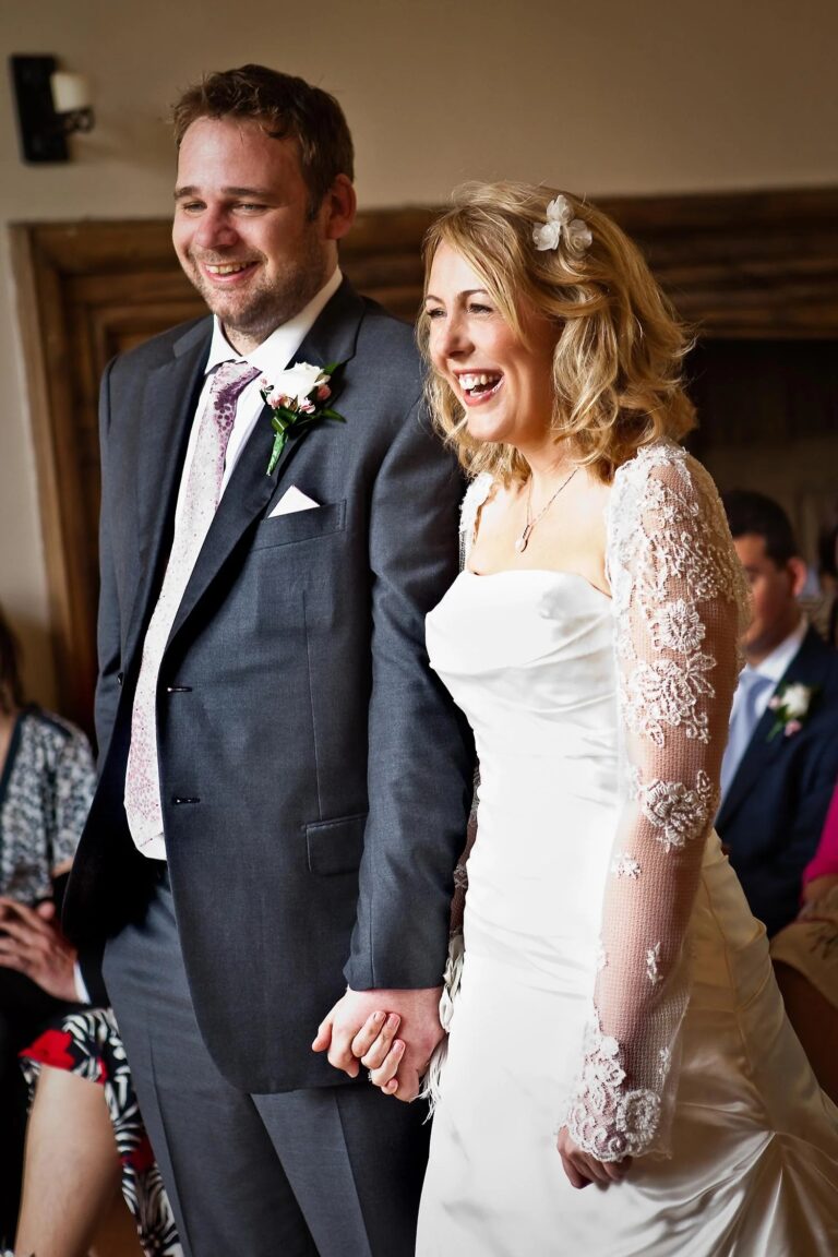 A bride and groom laughing together during their ceremony, Notley Abbey, Elizabeth Hsieh Make Up Artist