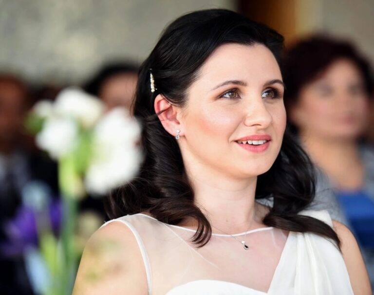 A bride at her ceremony, white lilies behind her, Kensington Roof Gardens, Elizabeth Hsieh Make Up Artist