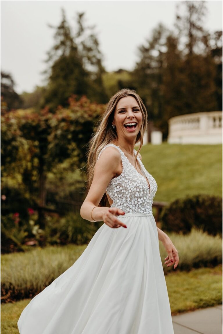 A bride laughing mid-stride through the gardens at Coworth Park, Ascot, Elizabeth Hsieh Make Up Artist